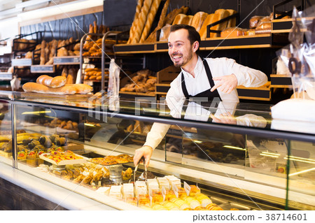Man offers a selection of baking 38714601