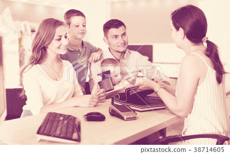 Happy family choosing material for mattress with saleswoman Happy family choosing material for mattress with saleswoman 38714605