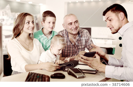 Cheerful family is choosing fabric for upholstery mattress Cheerful family is choosing fabric for upholstery mattress 38714606