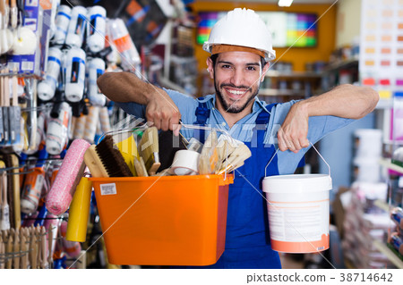 Adult workman holding paint and tools Adult workman holding paint and tools 38714642