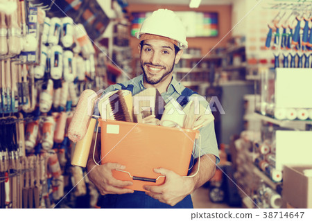 Positive guy painter holding basket with tools Positive guy painter holding basket with tools 38714647