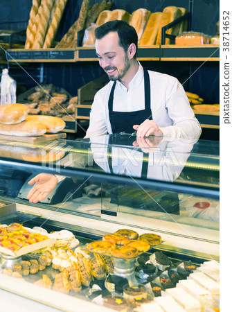 Seller offering fresh tasty bun Seller offering fresh tasty bun 38714652