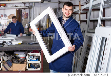 Workmen inspecting PVC manufacturing output in workshop 38715051