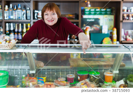 Glad seller woman offering different products 38715093