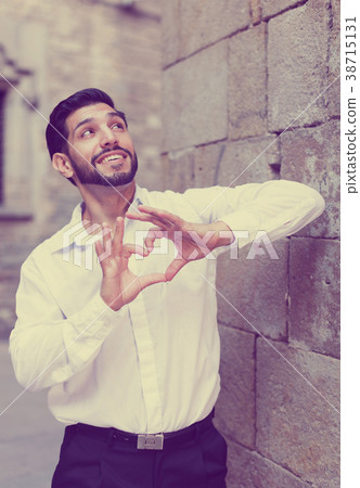 Man gesturing heart with his fingers 38715131