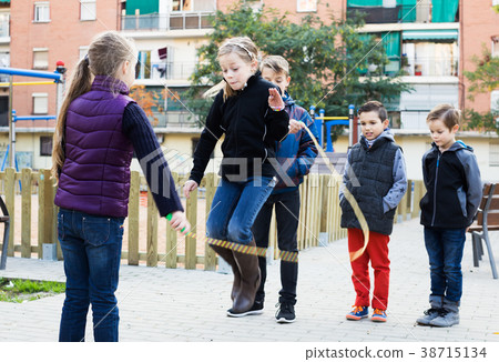Children playing skipping rope 38715134
