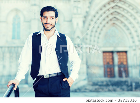 Waist up portrait of man near iron railings 38715316