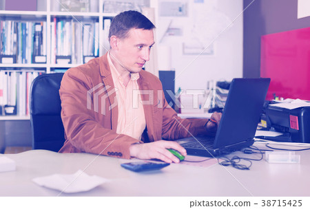 Portrait of concentrated manager working in agency office 38715425