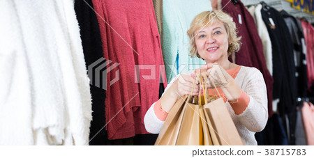 Woman in the dress boutique with paper bags 38715783