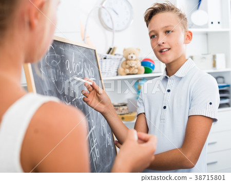 Friends are learning new theme on math and writing task on desk 38715801