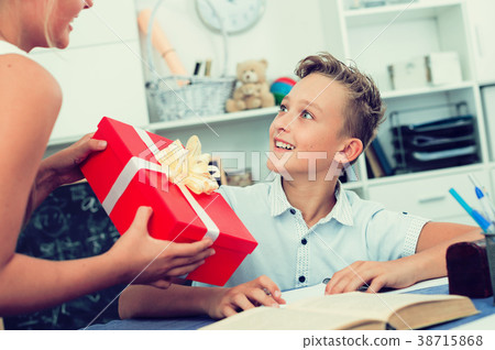 Sister is given to brother a box with surprises at celebrate 38715868