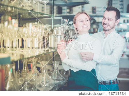 Couple choosing glasses in store Couple choosing glasses in store 38715884