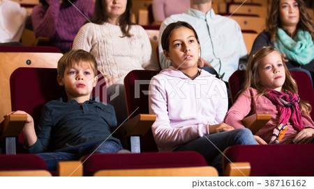 People enjoying film screening in cinema People enjoying film screening in cinema 38716162
