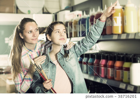 Mother and daughter holding jar with color paint 38716201