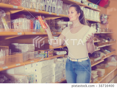 Woman choosing multi colored boxes Woman choosing multi colored boxes 38716400