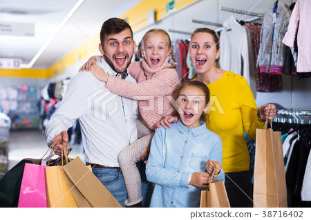 family of four with shopping bags family of four with shopping bags 38716402