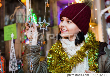 Teenage girl shopping at festive fair before Xmas Teenage girl shopping at festive fair before Xmas 38716412
