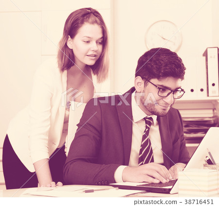 Business couple flirting in office 38716451