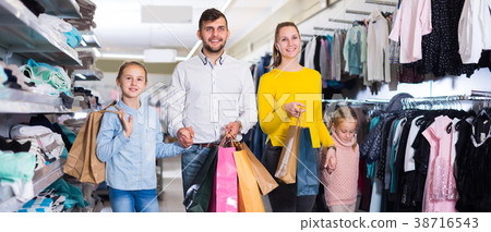 Smiling family walking in store after shopping Smiling family walking in store after shopping 38716543