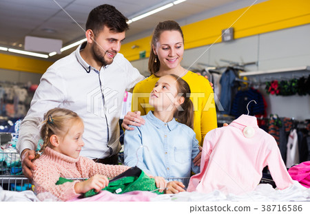 family with two girls choosing new clothes family with two girls choosing new clothes 38716586