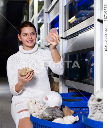 Girl choosing interesting large aquarian reefs 38716783