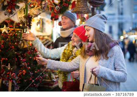 Happy couple with girl choosing decoration 38716789