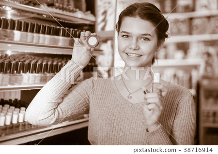 Smiling customer looking for make-up items 38716914