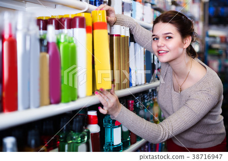 Teenage girl is searching for hair care products Teenage girl is searching for hair care products 38716947