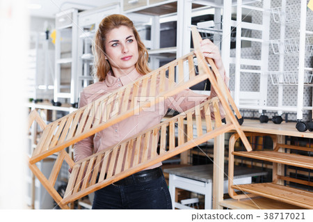Girl looking for shoe rack in shop 38717021