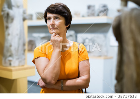 Female looking at museum exposition Female looking at museum exposition 38717638
