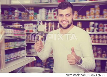 Glad man choosing new brush for decoration Glad man choosing new brush for decoration 38717639
