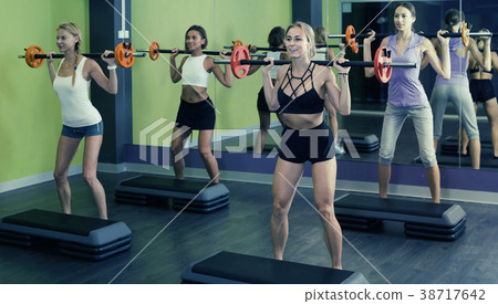 athletic girls during workout in gym with barbell athletic girls during workout in gym with barbell 38717642