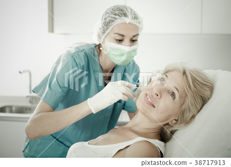 Mature female receiving cosmetic injection Mature female receiving cosmetic injection 38717913