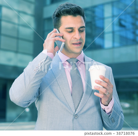 Business man talking on phone Business man talking on phone 38718076