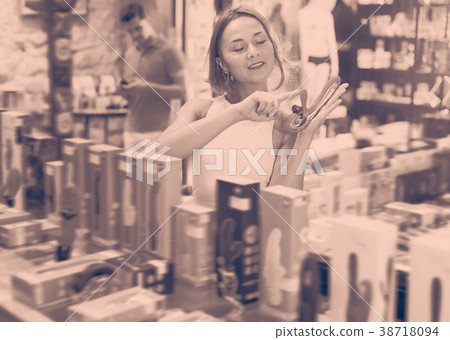 Portrait of young woman holding sexy toys Portrait of young woman holding sexy toys 38718094