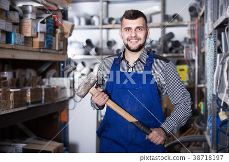 Worker man showing his constructing instruments Worker man showing his constructing instruments 38718197