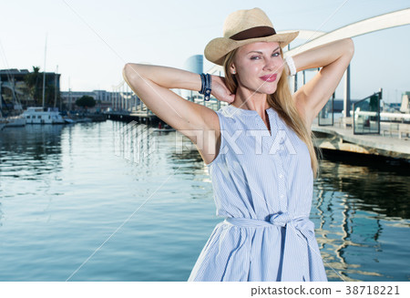 Portrait of smiling woman sitting in the hat Portrait of smiling woman sitting in the hat 38718221