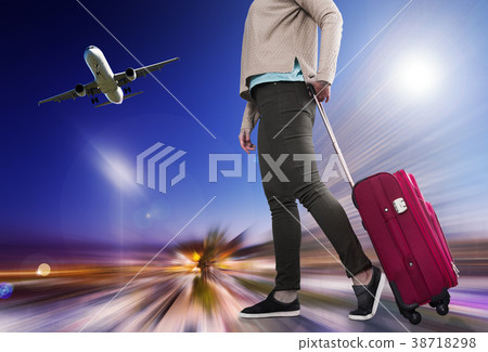 Woman carries luggage 38718298