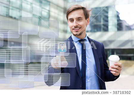 Man pressing icons on virtual touchscreen 38718302