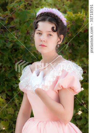 Romantic woman in an evening dress in the garden Romantic woman in an evening dress in the garden 38718591