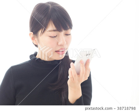 A woman talking to a smartphone 38718798