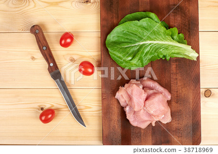 Raw turkey fillet pieces on a cutting board wooden 38718969