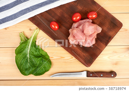 Turkey raw breast pieces on a cutting board wooden Turkey raw breast pieces on a cutting board wooden 38718974