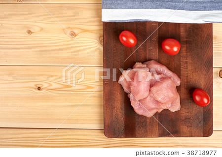 Raw turkey fillet pieces on a cutting board wooden Raw turkey fillet pieces on a cutting board wooden 38718977