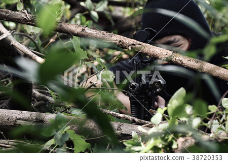 Soldiers aiming target and holding his rifles. 38720353