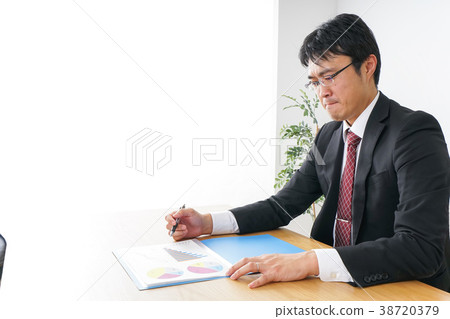 Businessman doing desk work Businessman doing desk work 38720379