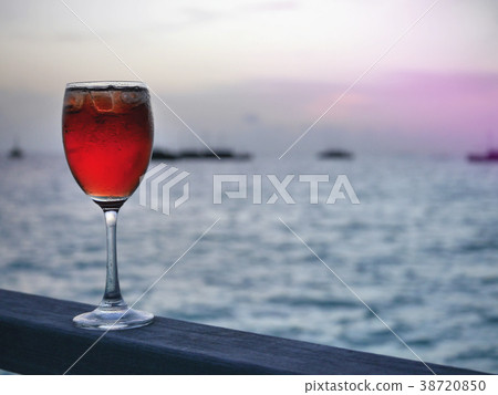Red iced cold beverage sunset Maldives background Red iced cold beverage sunset Maldives background 38720850