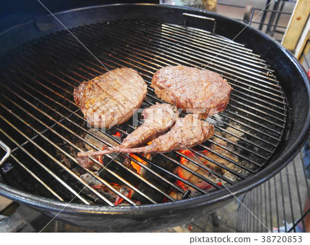 Pieces of cooked steaks on barbecue grill oven Pieces of cooked steaks on barbecue grill oven 38720853