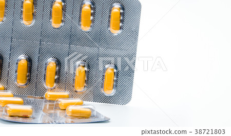 Orange capsule pills in blister pack isolated  38721803