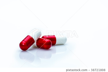 red, white antibiotics capsule pills isolated  38721808